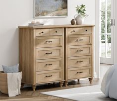 a bedroom scene with focus on the chest of drawers and an art piece in the background