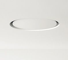 a white ceiling light that is on top of a wall in a room with no one around it