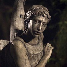 an angel statue is shown in black and white