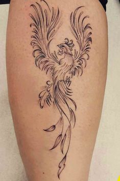 a woman's thigh with a bird tattoo on it