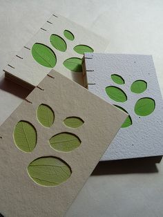 three pieces of paper with green leaves on them