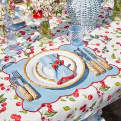 the table is set with flowers and place settings