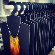 there are many necklaces on display in the store