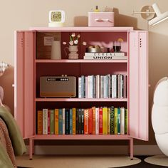 a pink bookcase with books on it in a bedroom