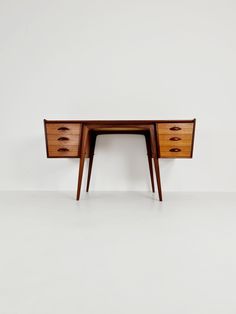 a wooden desk with two drawers on one side and an open drawer on the other