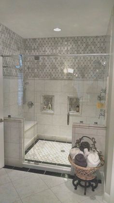 a bathroom with a walk in shower next to a sink