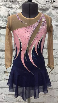 the figure skating dress is on display in front of a brick wall