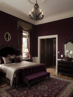 a bedroom with purple walls and a chandelier