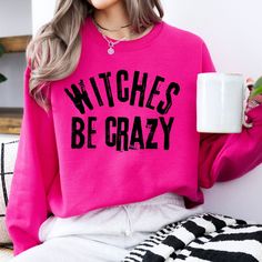 Witches be crazy Halloween sweatshirt, Witch crewneck, Funny holiday top, Spooky season, Women's fall sweater, Gift for girl, Sarcastic tee, Trick or Treat, Gift for mom, Gift for daughter, Gift for wife At ATTA TOOD, we offer a wide range of tees - from faith-based to family, funny, holiday, and beyond. Our faith is the foundation of our shop, but let's be real... we love to sprinkle in a little sass too!  ATTA TOOD tees are a whole mood.  Whether you're looking for something edgy, trendy, cool Spooky Funny Print Tops For Fall, Halloween Novelty Tops With Funny Print, Witches Be Crazy, Fun Long Sleeve Halloween T-shirt, Fall Witchy Crew Neck T-shirt, Fall Sweaters For Women, Witchy Halloween Crew Neck T-shirt, Sarcastic Tees, Be Crazy