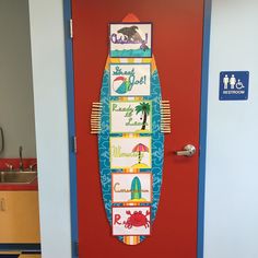 a surfboard painted on the front door of a school room with blue and red walls