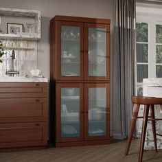 a kitchen with wooden floors and cabinets in the corner, along with a bar stool