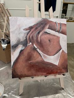 a painting of a woman's torso on an easel