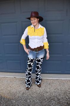 a woman in cowboy attire standing next to a garage door