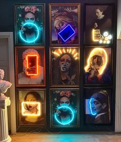 a bunch of framed pictures with neon lights on them in front of a wall that has portraits of clowns