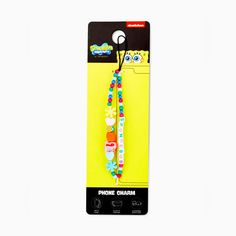 the phone charm is packaged in a yellow package with colorful beads and flowers on it