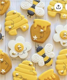 decorated cookies are arranged in the shape of bee's and honeybees on a white table