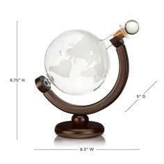 a glass globe on a wooden stand is shown with measurements for the size and shape