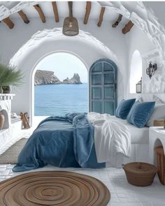 a bedroom with an arched window overlooking the ocean