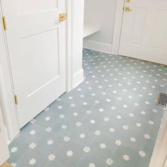 a white door is open on a blue tiled floor