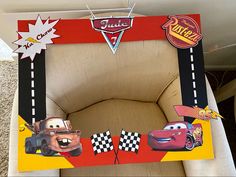 a cardboard chair with cars on it