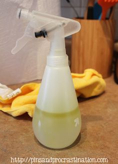 a hand sanitizer sitting on top of a counter next to a yellow towel