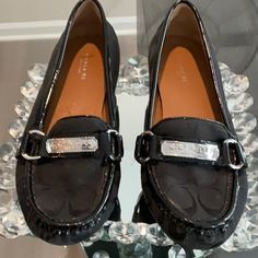 Nwot Coach Felisha Slip-On Black Driving Loafers With Coach Logo And Silver Buckle Detail Are Comfortable And Stylish!. They Are A Fabric Upper Loafer Trimmed In Black Patent Leather With A Round Toe And A Leather Insole. These Casual Shoes Are In Excellent Condition And Have Never Been Worn But Due To Storage Have Peeling On The Inside Of The Shoes. The Exterior Is In Excellent Condition And Has No Callouts. Please See All Photos. Heel Height: Flat (0 To 1/2 In.) Coach Elegant Formal Loafers, Elegant Coach Loafers For Formal Occasions, Elegant Coach Loafers With Round Toe, Classic Silver Flats With Round Toe, Coach Formal Loafers With Round Toe, Coach Loafers With Flat Heel For Formal Occasions, Coach Formal Loafers With Flat Heel, Coach Formal Flat Heel Loafers, Elegant Coach Loafers With Flat Heel