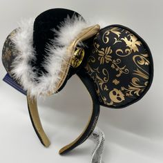 a black and gold mickey mouse hat with white feathers