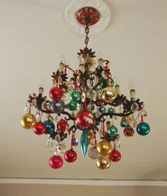 a chandelier with ornaments hanging from it's ceiling