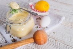 an image of some food that is in a jar on the table with utensils