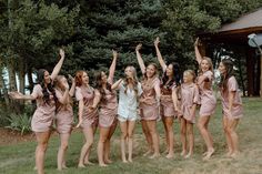 a group of young women standing next to each other on top of a lush green field