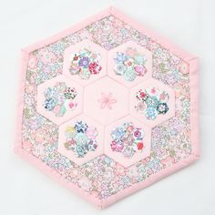 a hexagonal patchwork piece with flowers on it