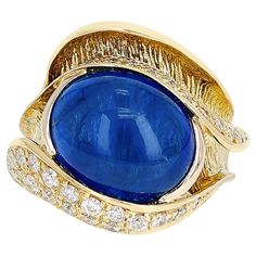 A 10.48 ct. Sapphire Cabochon and 0.54 ct. Diamond Cocktail Ring made in 18 Karat Yellow Gold. Ring Size US 6.50. The total weight is 12.60 grams. Sapphire Cabochon, Diamond Cocktail Ring, Diamond Cocktail Rings, Yellow Gold Ring, Cocktail Ring, Cocktail Rings, Gold Ring, Amazing Women, Jewelry Rings