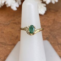 Estate/ vintage 14KT yellow gold ring with oval, genuine emerald + diamond accents. Stunning deep, green color on this emerald. Emerald is the birthstone for May babies + this ring makes a fantastic gift! Size 6.5 Weight: 2.10g Genuine, oval-cut, emerald measures: 6.5mm x 5mm .65~ .70 CT natirual diamonds (6) round diamonds; SI/I clarity; I color Stamped 585 (14K) Excelent estate condition Fine Jewelry Emerald Oval Cabochon Ring For May Birthstone, Green Oval Diamond Ring Fine Jewelry, Oval Emerald Ring With Diamond Accents For May Birthstone, Heirloom Oval Emerald Ring, Heirloom Oval Emerald Ring As May Birthstone, Green Emerald Oval Cabochon Ring Stamped 14k, Gold Emerald Ring For May Birthstone, Oval Shape, Green Emerald Oval Diamond Ring, Heirloom Oval Emerald Ring Birthstone