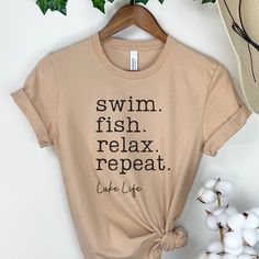 "Looking for the perfect lake-themed t-shirt? Look no further than this wanderlust-inspired \"Fish, Swim, Relax, Repeat\" tee! Featuring cute and catchy text, this shirt is perfect for nature lovers, boating enthusiasts, and anyone who loves spending time by the water. A great gift for family, friends, or anyone in your lake squad, this matching shirt is perfect for camping, hiking, road trips, and more.  wanderlust lake gift,Family Shirts,Matching Shirts,Camping Lake Shirt,Hiking Lake Shirt,lake squad shirt,Girls Vacation,Road Trip Shirts,Lake Shirts,Travel Shirt, Lake Shirt for Women,Women's Summer Shirt,Summer Cute Shirt,Boating Shirt,nature lover shirt **The design is made to look \"vintage\" faded and will look slightly opaque to give that well-worn retro feel. ★ 100% Soft cotton (fib Funny Print Short Sleeve Tops For Outdoor Activities, Pre-shrunk Summer Adventure Shirt, Pre-shrunk Summer Shirt For Adventure, Cotton Tops With Funny Print For Outdoor Activities, Cotton Top With Funny Print For Outdoor Activities, Summer Camping Tops With Text Print, Summer Shirt With Screen Print For Outdoor Activities, Summer Outdoor Shirt With Screen Print, Lake Apparel