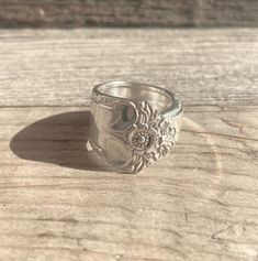 a silver ring sitting on top of a wooden table