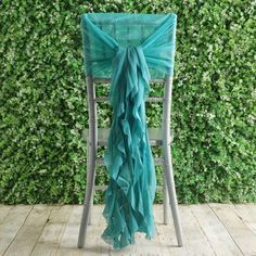 a chair with a green scarf draped over it