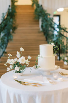 a white wedding cake sitting on top of a table