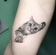 a small cat tattoo on the leg