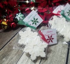 three snowflakes are wrapped in cellophane and sitting on a table