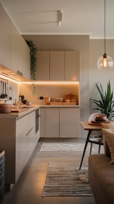 a living room filled with furniture next to a kitchen