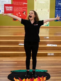 a woman standing on top of a fire rug