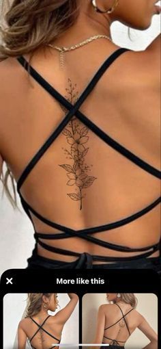 the back of a woman's dress with flowers on it and an arrow tattoo