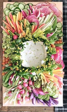 an arrangement of vegetables arranged on a cutting board