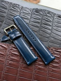 "This blue watch strap is made from the premium and highly sought-after Shell Cordovan leather. Known for its durability, strength, and unique shine, Shell Cordovan leather is the ultimate choice for a high-quality leather strap. The natural oils in the leather give it a distinctive luster that will only improve with age. The hand-stitching adds to its classic aesthetic, while the sturdy construction ensures that it will last for years to come. Whether you're looking for a timeless accessory or simply want a durable and stylish watch strap, this handmade Shell Cordovan option is the perfect choice. Details :  Topside: Shell Cordovan Luxury Leather All of our Handmade Leather Watch Strap and other product are fully personalizable, please just let me know what would you like to personalize / Luxury Blue Watch Band For Business, Luxury Blue Watch Bands For Business, Luxury Blue Business Watch Bands, Blue Rectangular Business Watches, Classic Blue Watches With Stainless Steel Clasp, Classic Blue Rectangular Watch Accessories, Luxury Blue Watch For Everyday Use, Luxury Blue Watches For Everyday Use, Luxury Blue Everyday Watch