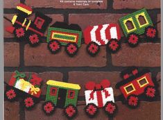 a book cover with crocheted train decorations on brick wall in front of bricks