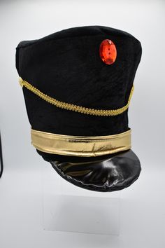 This season complete your look with this Black Velveteen Toy Solider Hat. Featuring a red faux gem, gold band and draped cord. Great for Majorette or Toy Soldier costume! Perfect for Halloween, Christmas, Cosplay, Theater and more. This soft hat is about 9.25 inches tall 10.5 inches long, and 8.5 inches wide. Cap measures approximately 59 cm or 23 inches. Great for Men, Women, and Teens. Spot clean only. For ages 14 and older. ⭐Black Velveteen Toy Solider Hat. Great for Majorette or Solider!  ⭐This soft hat is about 9.25 inches tall 10.5 inches long, and 8.5 inches wide. ⭐Featuring a red faux gem, gold band and draped cord, and shiny brim/bill. ⭐Cap measures approximately 59 cm or 23 inches. Great for Men, Women, and Teens. ⭐Perfect for Halloween, Christmas, Cosplay, Theater and more. Spot Gold Costume Accessories For Halloween Cosplay, Adjustable Gold Costume Accessories, Themed Costume Accessories For Christmas Cosplay, Themed Christmas Costume Accessories For Cosplay, Adjustable Gold Costume Accessories For Cosplay, Themed Christmas Cosplay Costume Accessories, Adjustable Christmas Costume Party Accessories, Gold Adjustable Costume Accessories For Costume Party, Gold Adjustable Costume Accessories For Party