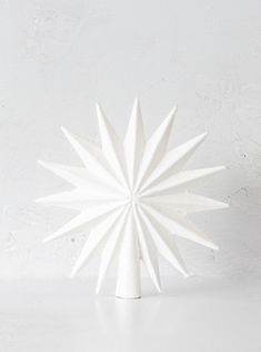 a white vase sitting on top of a table