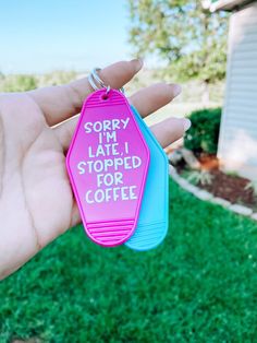 someone is holding up two tags that say sorry i'm late, stopped for coffee