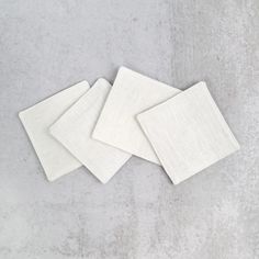 three white napkins sitting on top of each other