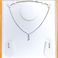 Elevate your style with this Graceful Diamond Tassel Necklace Set. Crafted with 18k white gold and 2.94ct diamonds in round shape, this set has a set length of 17" and a drop length of 1". It features a push lock with clasp and comes with matching earrings. The necklace has a weight of 30.8g, making it a perfect addition to your high fashion wardrobe. PRODUCT DETAILS Gold Purity(karat): 18k Item Weight(grams): 30.8 Item Finish: White Gold Stone: Diamond Diamond Weight(carats): 2.94ct Diamond Col Elegant Dangle Diamond Necklace For Formal Occasions, Elegant Formal Diamond Dangle Necklace, Elegant Formal Dangle Diamond Necklace, White Gold Diamond Jewelry Sets For Evening, Formal White Gold Rhinestone Necklace, Silver Dangle Diamond Necklace For Formal Occasions, 18k Gold Necklace, Lock Style, Gold Necklace Set